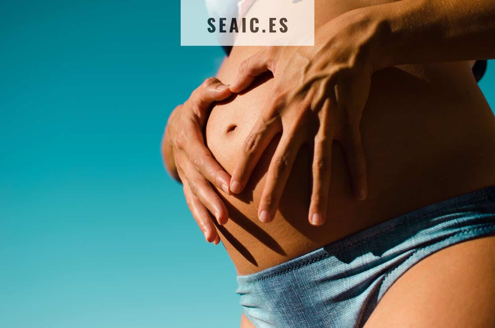 closeup photography of pregnant woman wearing blue panty