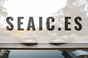 a pool with two lounge chairs and a view of a house